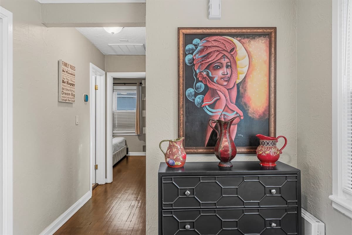 Tastefully decorated hallway with artwork and accents adding character to the home.