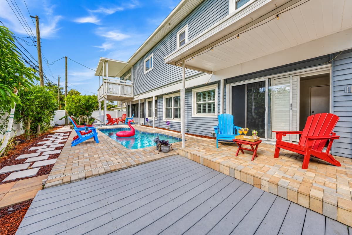 Spacious deck area overlooking the pool with multiple seating spots—perfect for relaxing and entertaining 