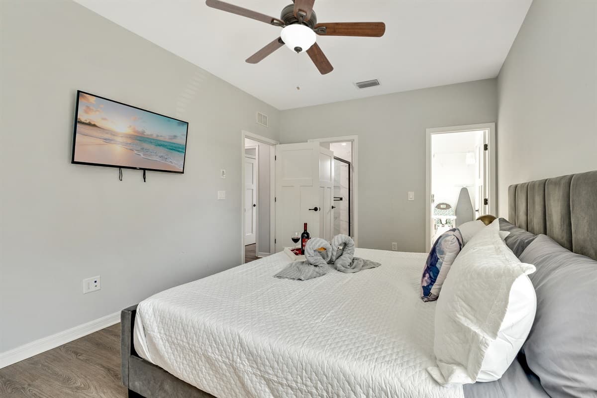 Draped in sumptuous linens and adorned with plush pillows, the bed is a sanctuary of comfort and style.