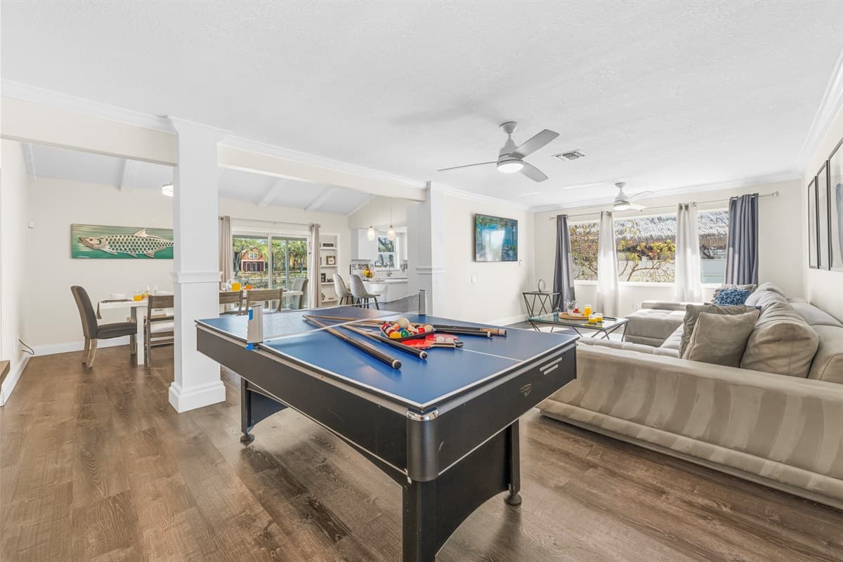 Open floor plan connects the game room, dining area, and living room for easy gathering.
