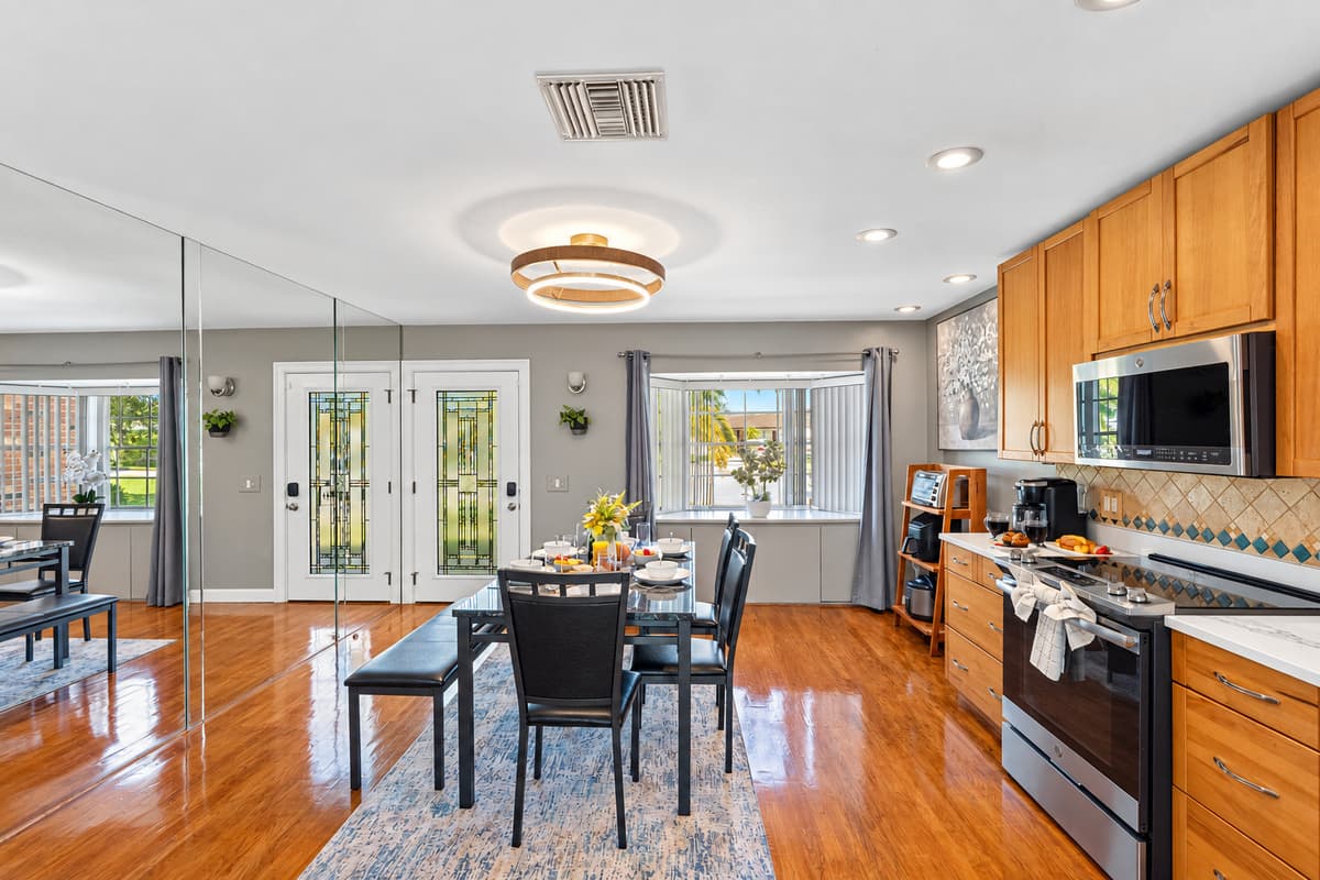 This stylish dining area flows seamlessly into the kitchen and living space, creating the perfect setting for both everyday meals and special gatherings.