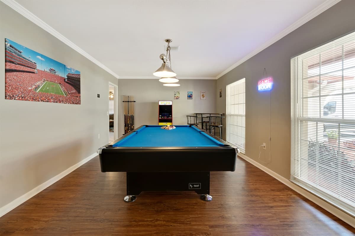 The centerpiece of this gaming haven is an iconic PAC MAN arcade machine, a timeless classic that transcends generations.