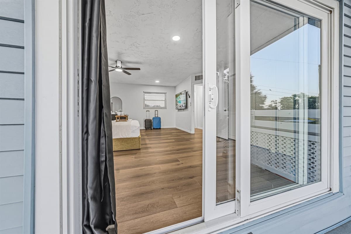 View from inside the bedroom looking out to the private balcony—seamless indoor-outdoor living 