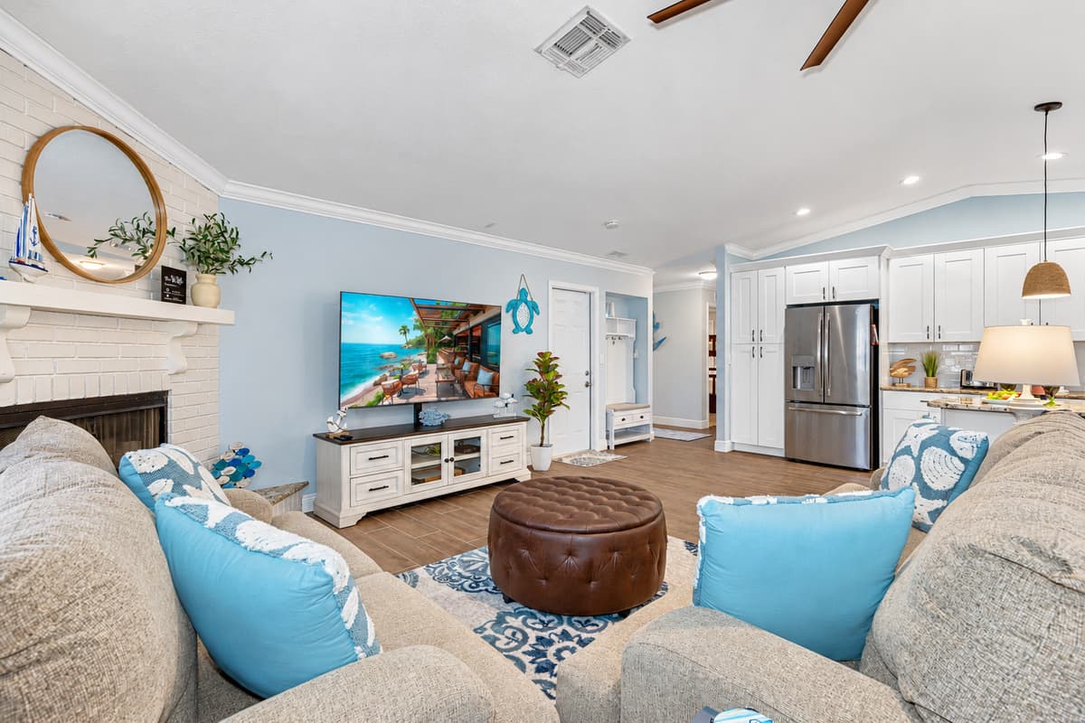 The living area is designed to be a sanctuary of relaxation and style, featuring comfortable, plush couches that invite you to unwind and enjoy.