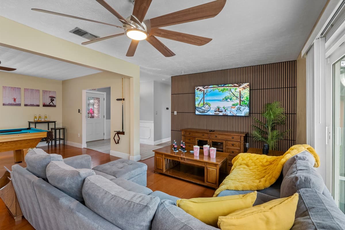 Bright and airy living space with seamless flow to the dining and game areas.