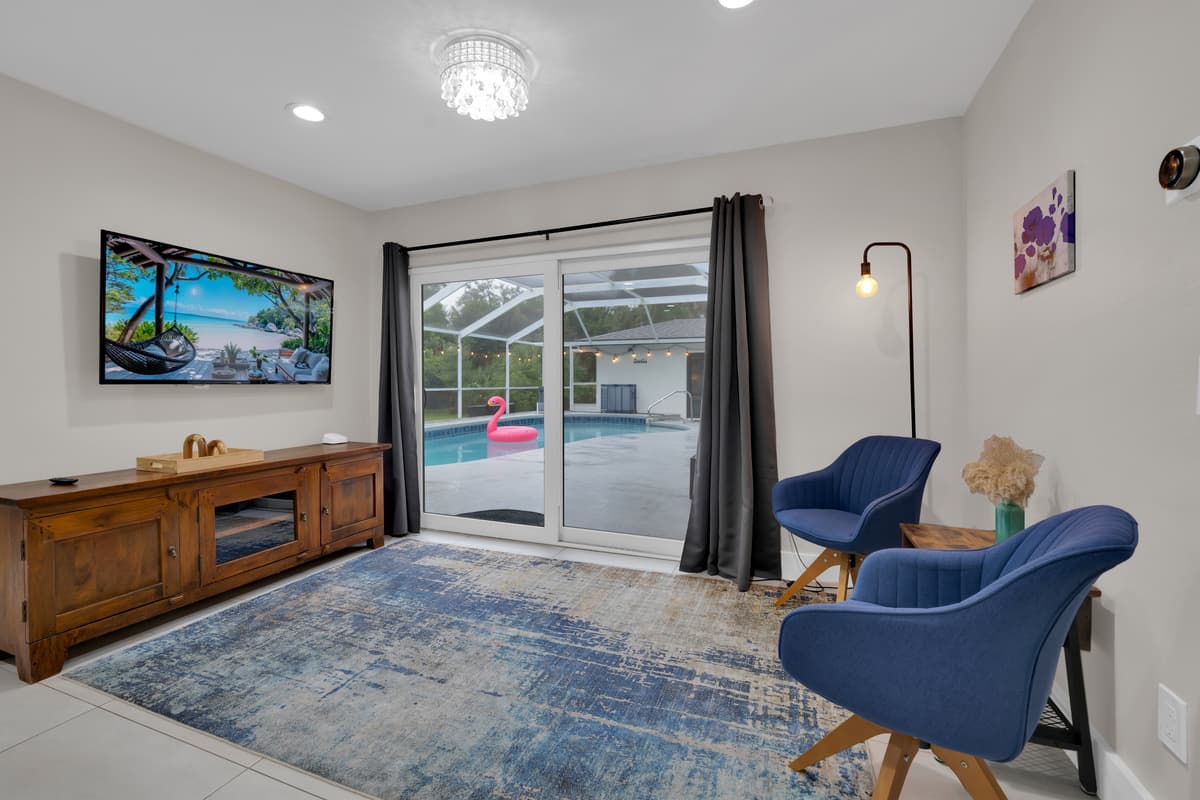 This isn't just a bedroom, it's a suite with its own sitting area and direct access to the pool just past the sliding glass.