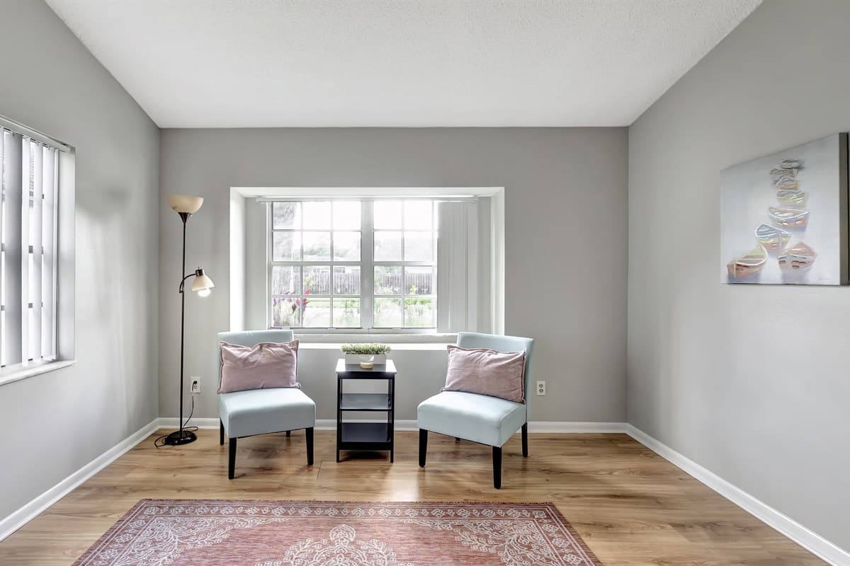 An aesthetically pleasing extra seating nook bathed in natural light by the window.