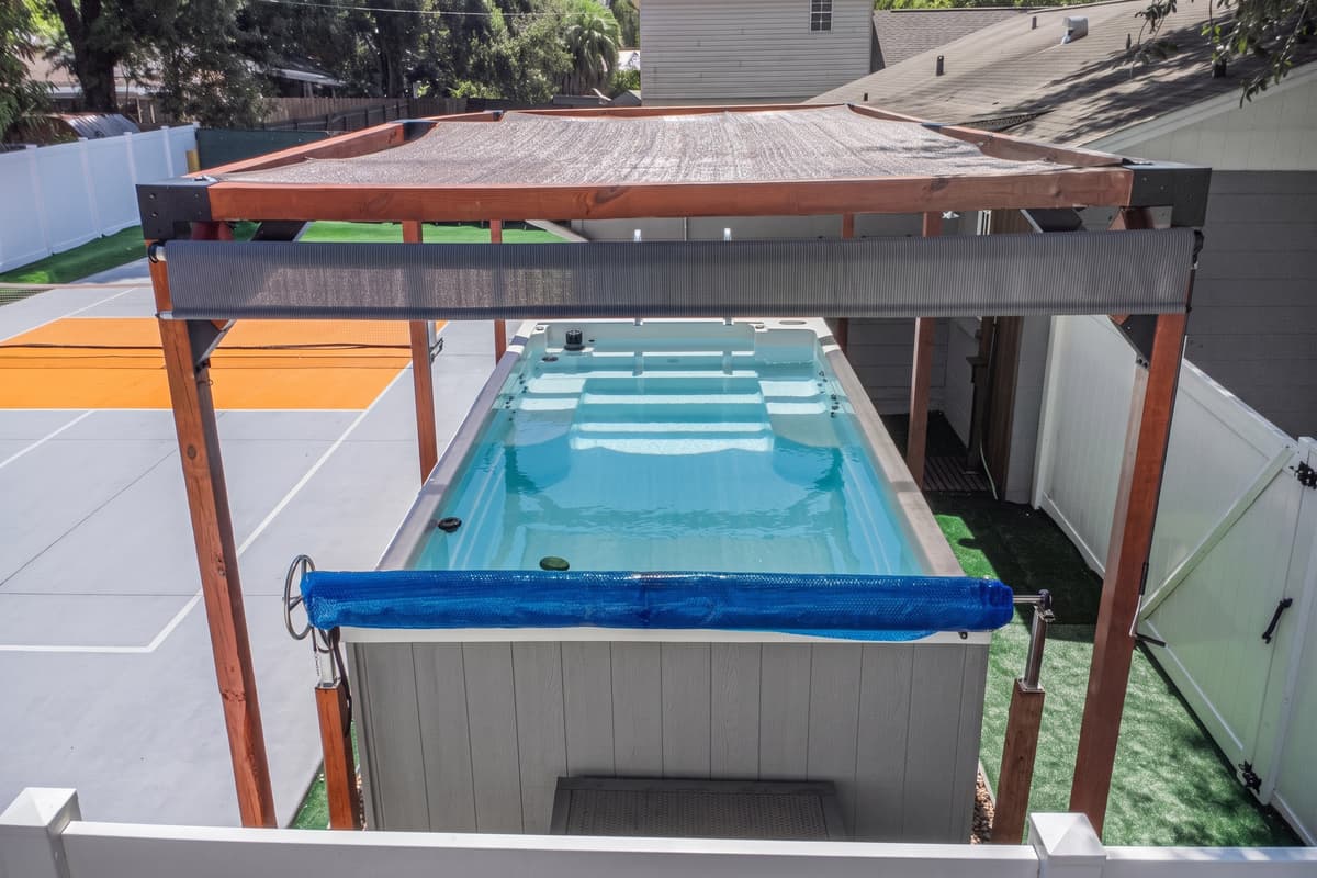 The spacious swim spa features built-in seating and a swim current, making it ideal for both relaxation and low-impact exercise.