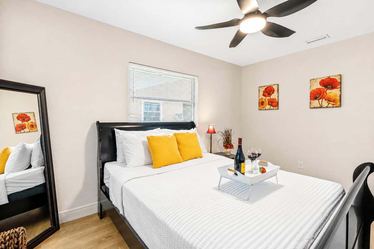 The room features soft beige walls, light wood flooring, and white trim, creating a calm and neutral backdrop that enhances relaxation.