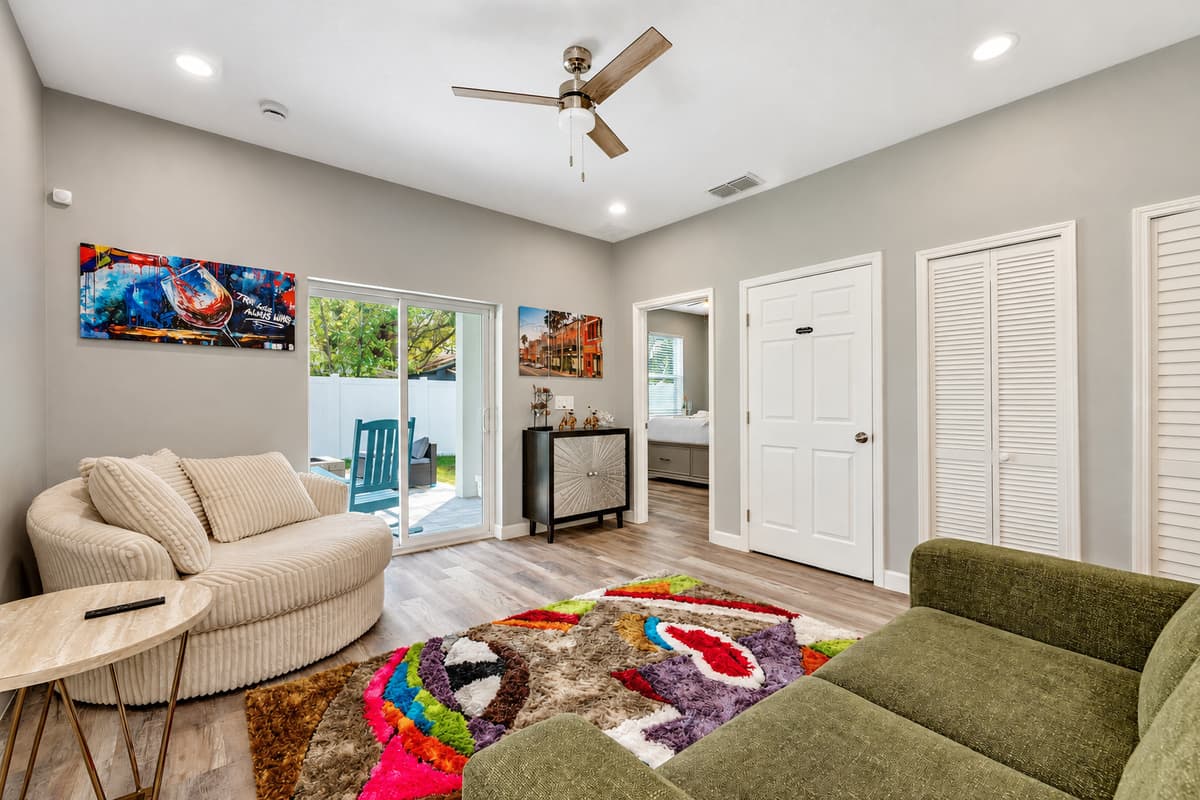 The room is bathed in natural light, thanks to large windows that offer sweeping views of the surrounding landscape.
