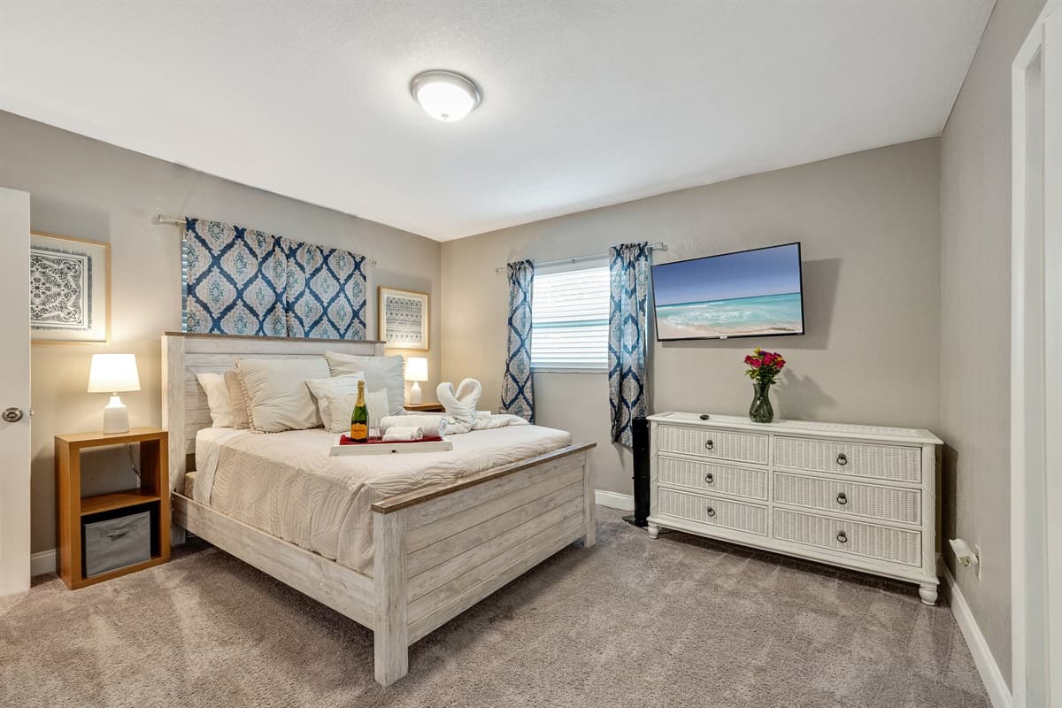 Draped in sumptuous linens, the bed beckons with promises of restful nights and lazy mornings.
