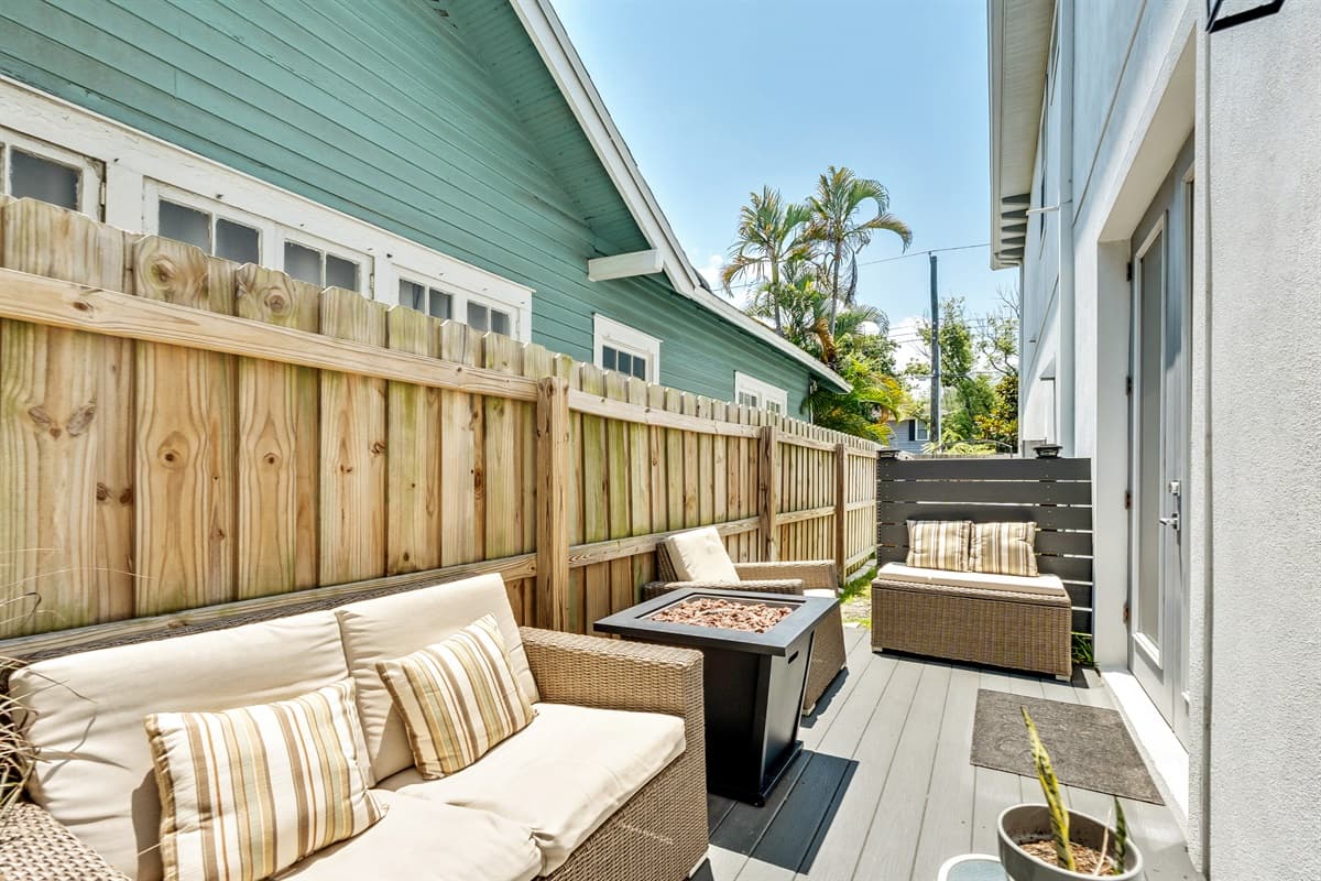 At the heart of this outdoor sanctuary is a beautiful fireplace, its dancing flames casting a warm and inviting glow that transforms the space as dusk falls.