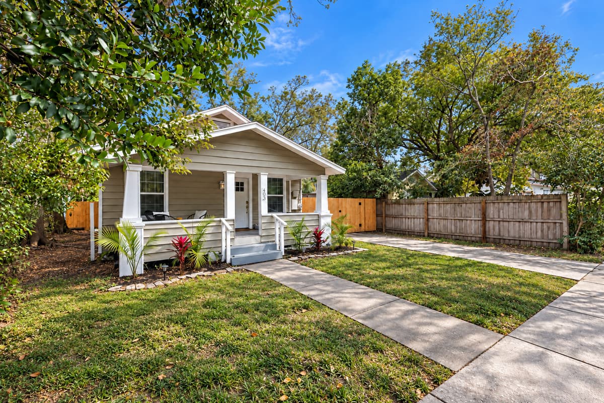 Curb appeal is nice; a fenced yard and off-street parking are useful. This bungalow has both, on a quiet residential block where the loudest thing most nights is the air conditioner. Clearwater Beach is still only eight minutes west of here.