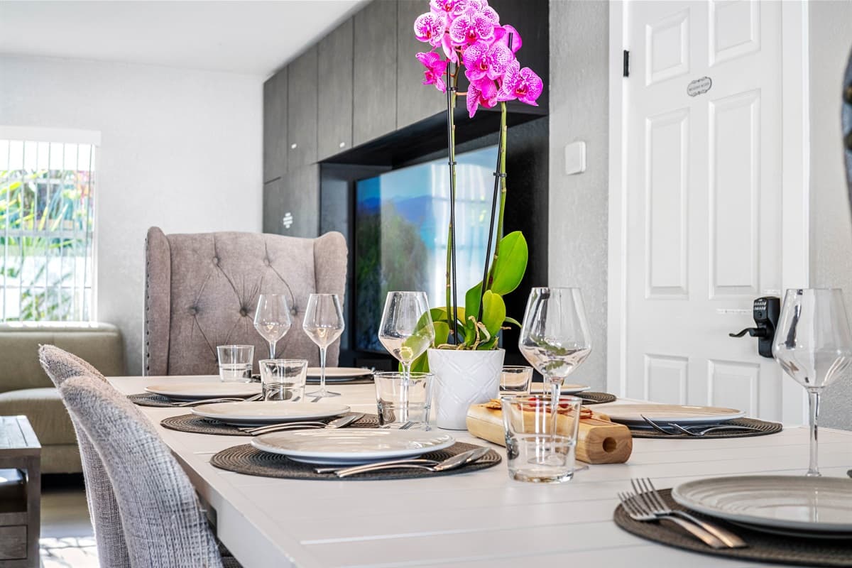 Our pristine dining area comfortably accommodates 8 people and is conveniently located next to our fully equipped kitchen, allowing you to prepare and enjoy your favorite homemade meals.