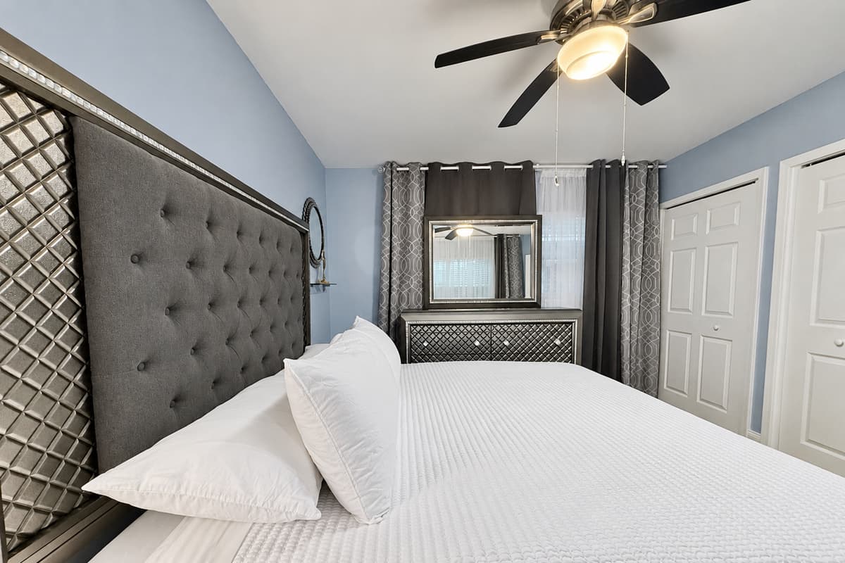 Sleep like royalty in this beautifully appointed room with a luxurious king bed, plush linens, and chic mirrored accents.