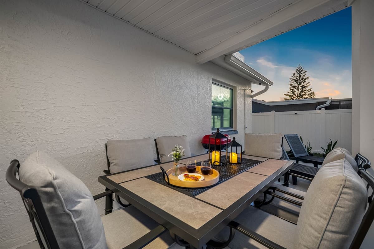 Step outside to your private oasis featuring a shaded dining space, poolside lounge chairs, and cozy furnishings. The perfect spot to soak up the Florida sun or enjoy a meal under the fan-cooled patio.