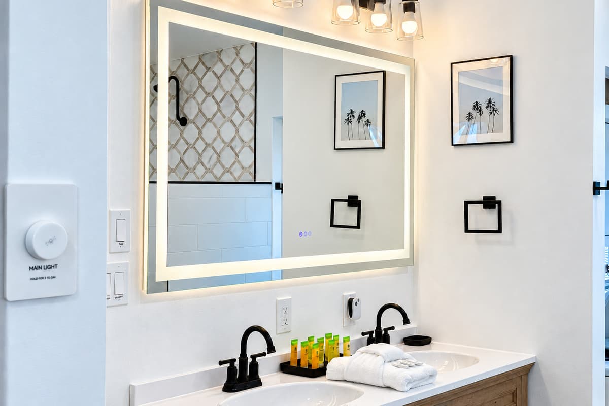 Bathroom 1 double vanity and large mirror.