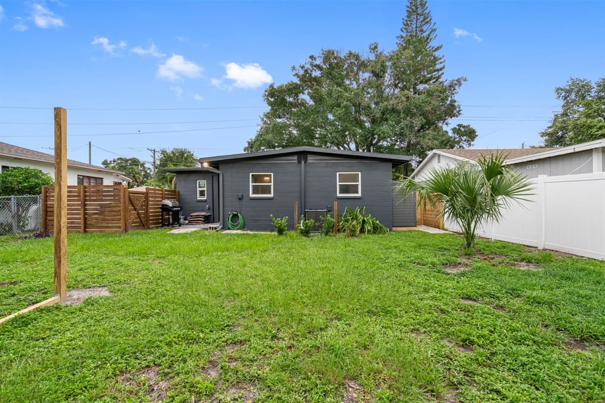 The backyard features lush, green grass creating a serene atmosphere.