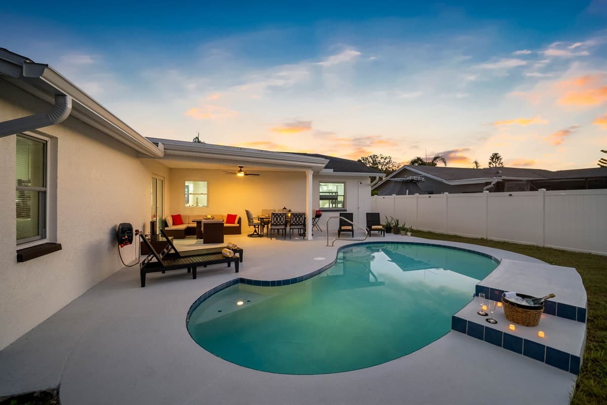 Watch the sky paint itself in color while you relax in this beautifully designed backyard featuring a tranquil pool and stylish patio lounge.