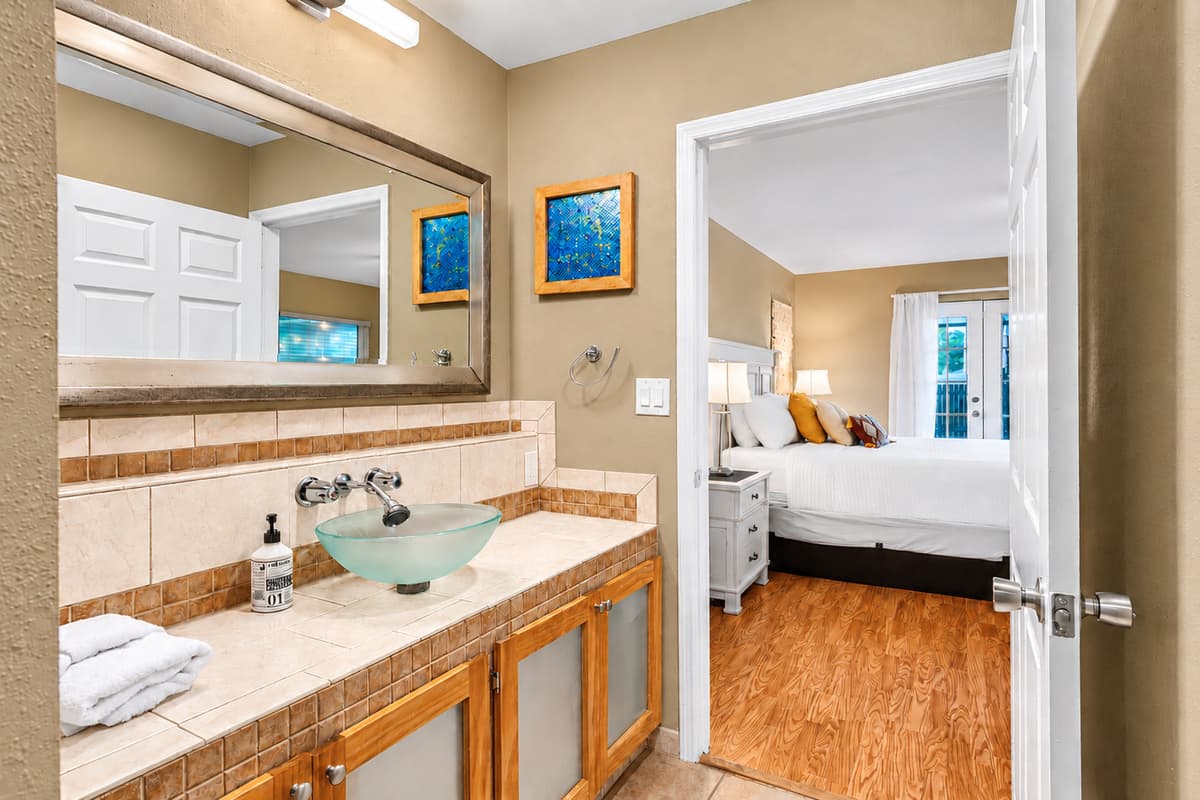 Cozy ensuite bathroom with stylish finishes, warm tones, and convenient bedroom access.