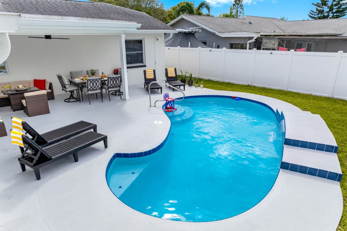 A backyard paradise with a modern pool, cozy patio, and peaceful atmosphere — your private sanctuary awaits.