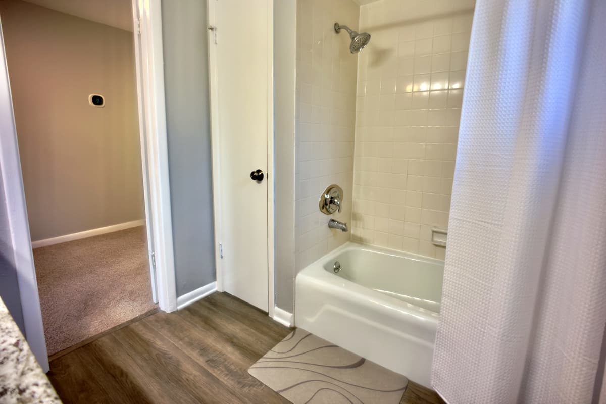 A serene retreat featuring a tub and shower combination, perfect for unwinding after a long day.