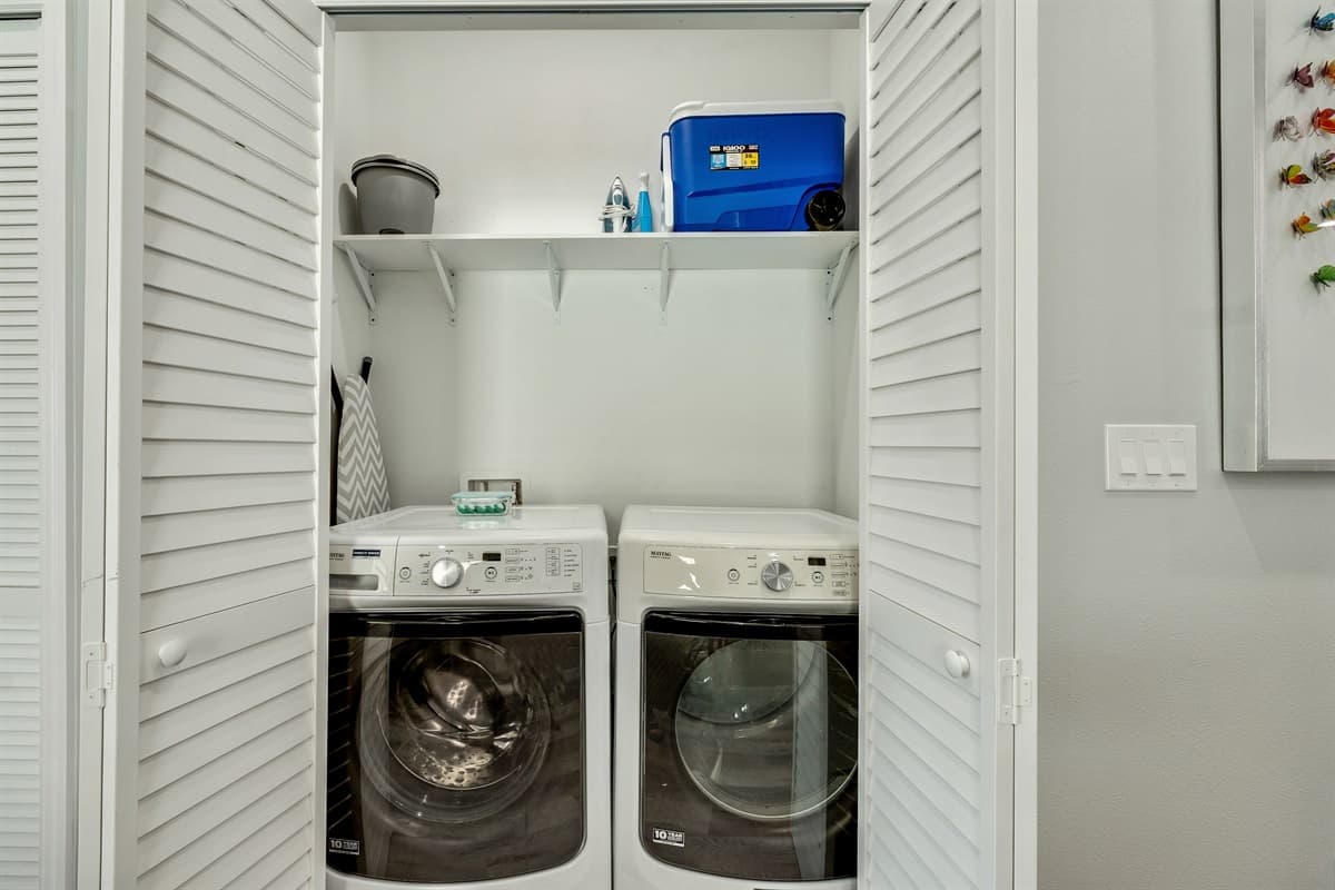 This room is your haven for quick and convenient laundering. Efficiency meets comfort in this contemporary laundry space.