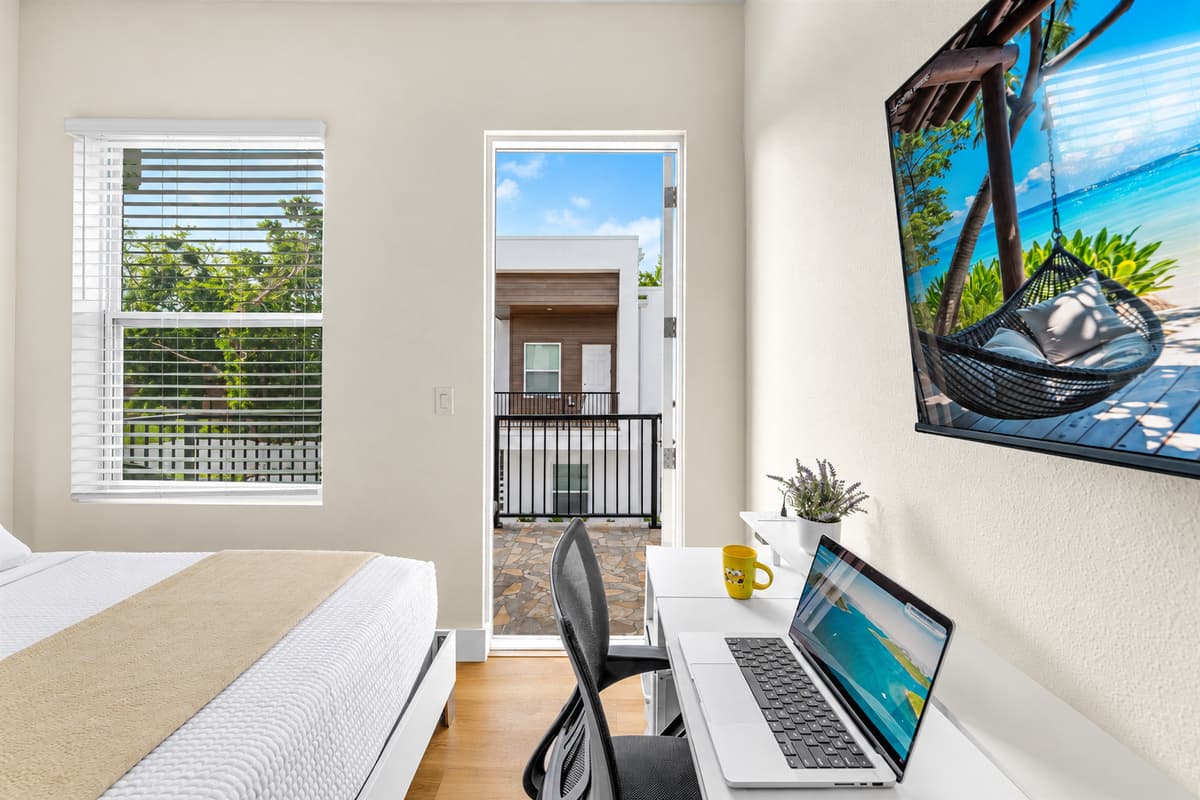 Workspace with natural light and balcony access—ideal for remote work.
