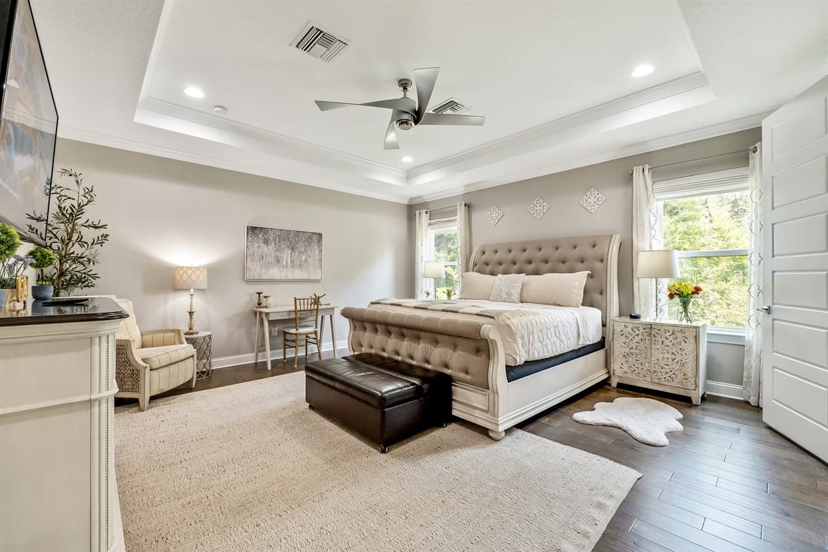 Large windows flood the room with natural light during the day, offering views of the surrounding landscape and adding to the sense of openness and tranquility.