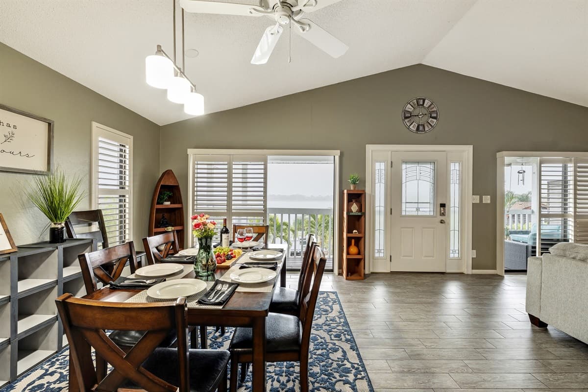 Beautiful wooden dining table accompanied by comfortable chairs, providing seating for up to six people, fronting the beautiful view of the lake.