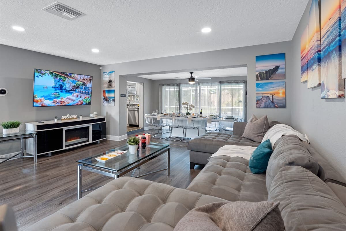 With its oversized sectional, calming coastal artwork, and a massage chair tucked in the corner, this living room is built for serious relaxation.