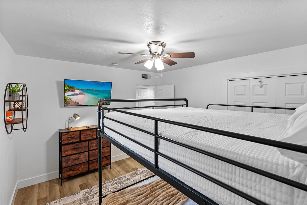 Perfect for kids or friends, this cozy bunk room features a full-over-full setup with clean lines, warm accents, and plenty of natural light.