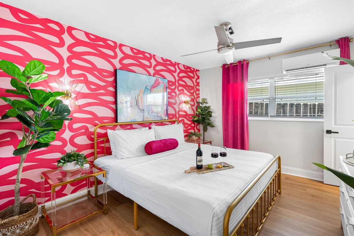 Tropical-inspired throw pillows and a cozy blanket add a touch of Miami's beachfront relaxation to the space.
