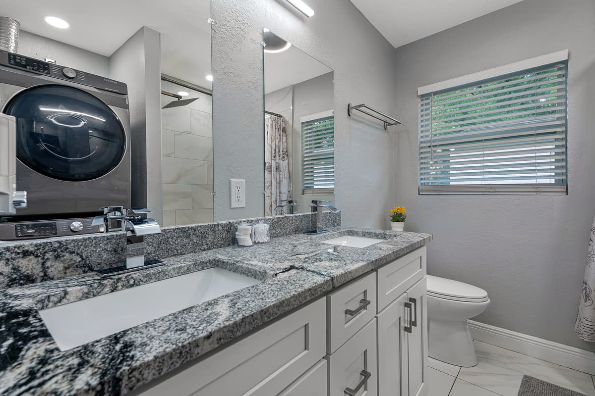 Stunning bathroom has his and hers sink, toilet, bathtub and a shower. Enjoy a relaxing bath after a long day of travel from your home to your home away from home. If you like this property, send us a message now!