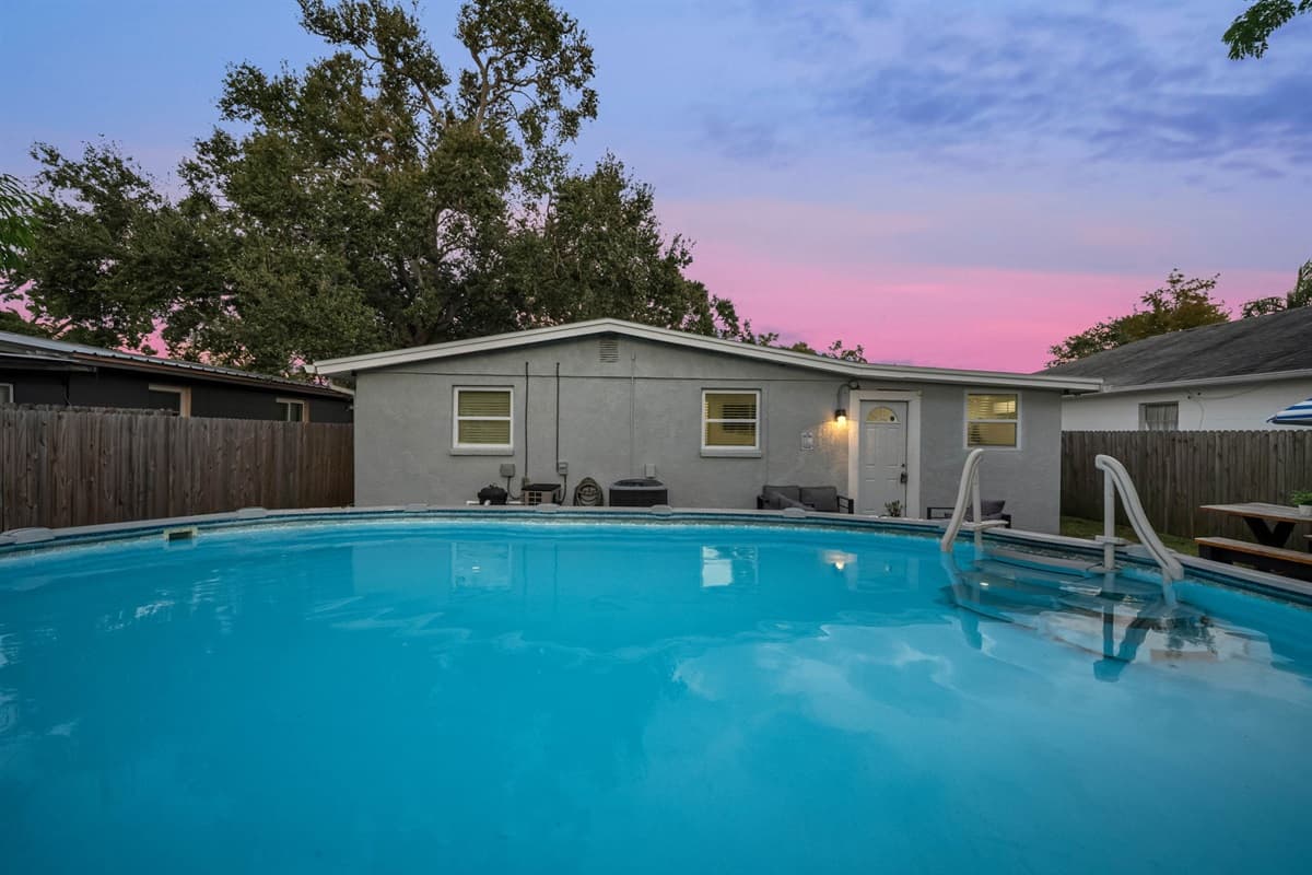 Watch the sky turn pink and purple as you relax by the softly lit pool at sunset.