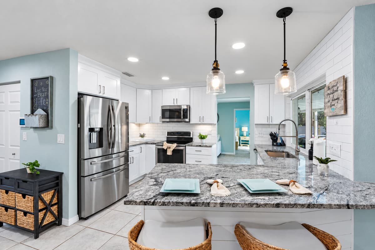 Enjoy a fresh, airy kitchen with ample counter space, modern lighting, and everything you need for a home-cooked meal.