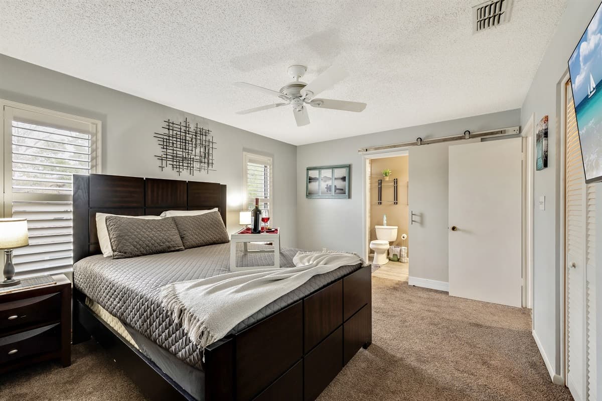 Thoughtfully selected furnishings, from bedside tables to cozy seating arrangements, add an extra layer of comfort to the space.