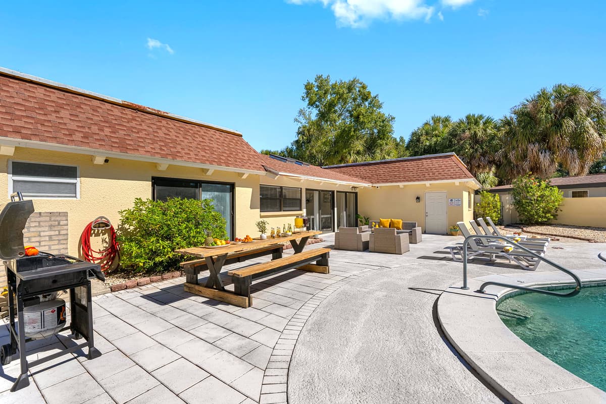 This spacious pool deck comes complete with loungers, a BBQ grill, and a dining table — perfect for enjoying Tampa’s sunny days and starry nights.