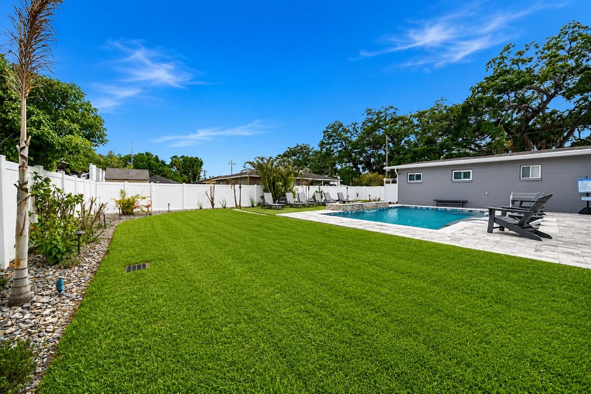 Expansive backyard space featuring a large manicured lawn, private pool, and plenty of room for outdoor fun and relaxation.