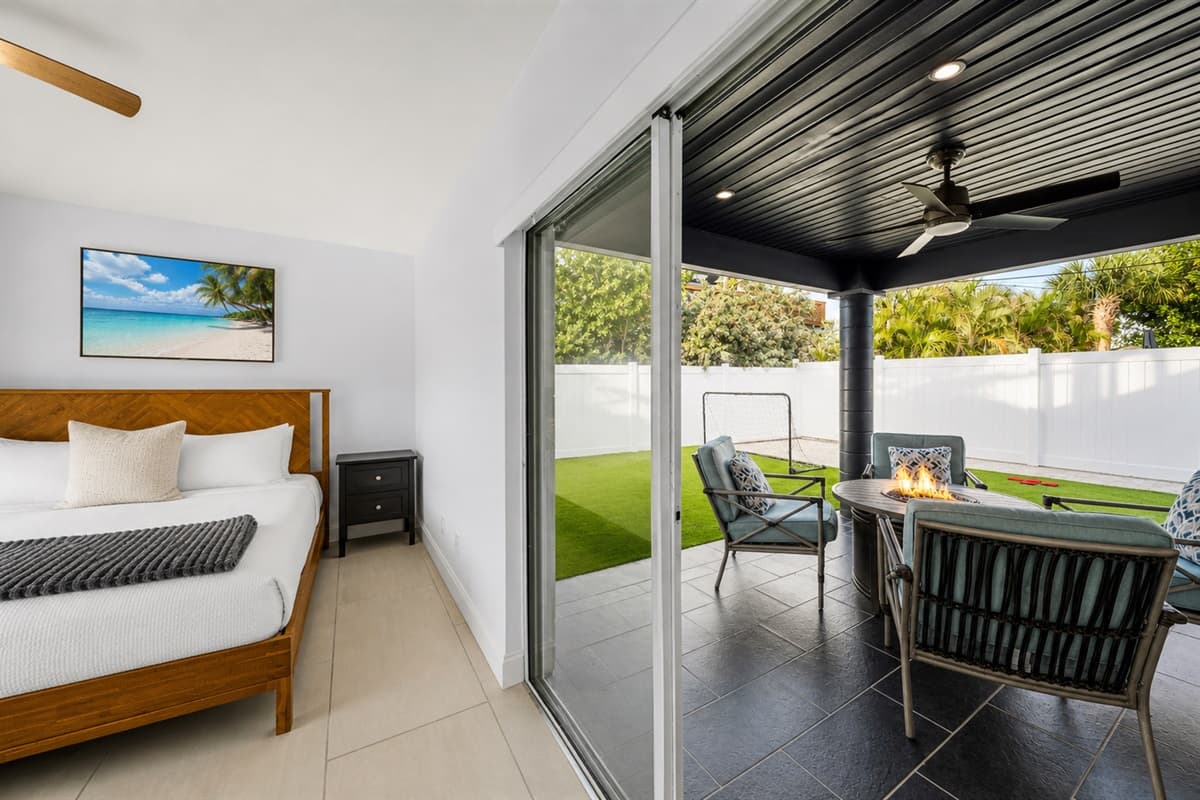 Bedroom view overlooking the covered patio and private outdoor lounge area.