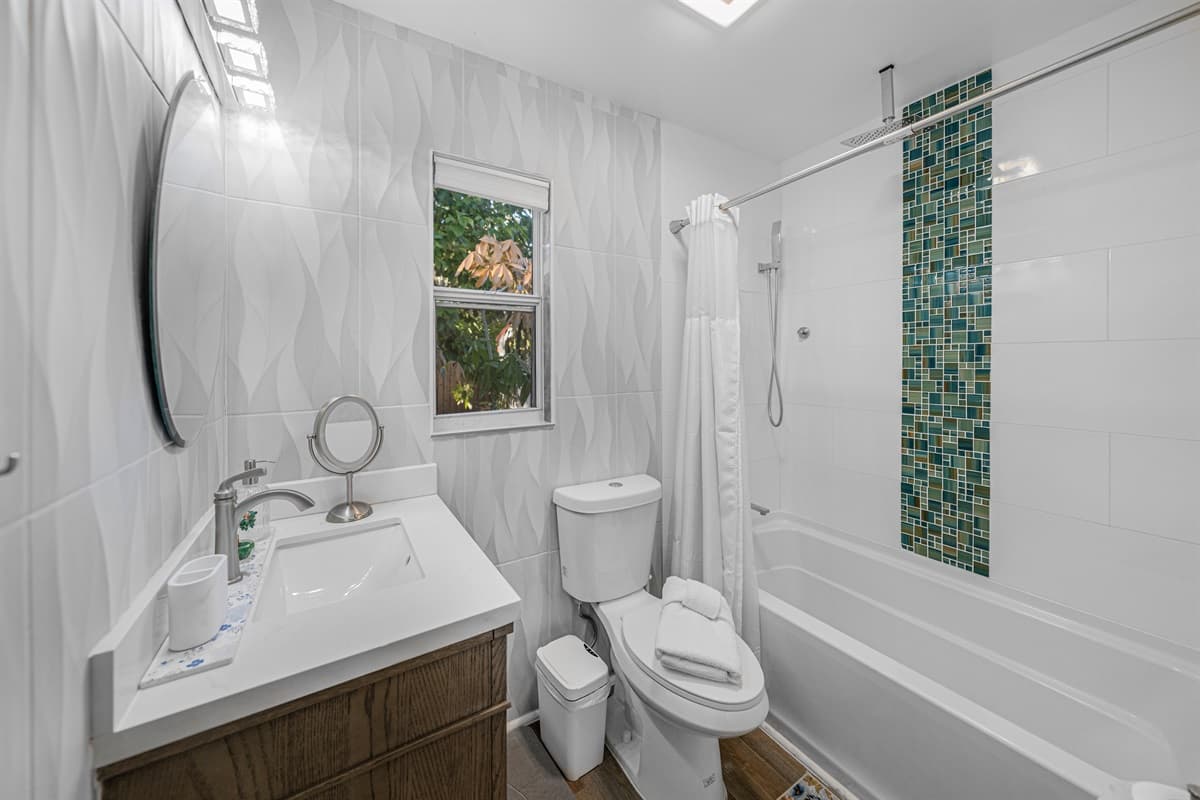 This bright, modern bathroom features clean finishes, stylish tilework, and a fresh, spa-like feel.