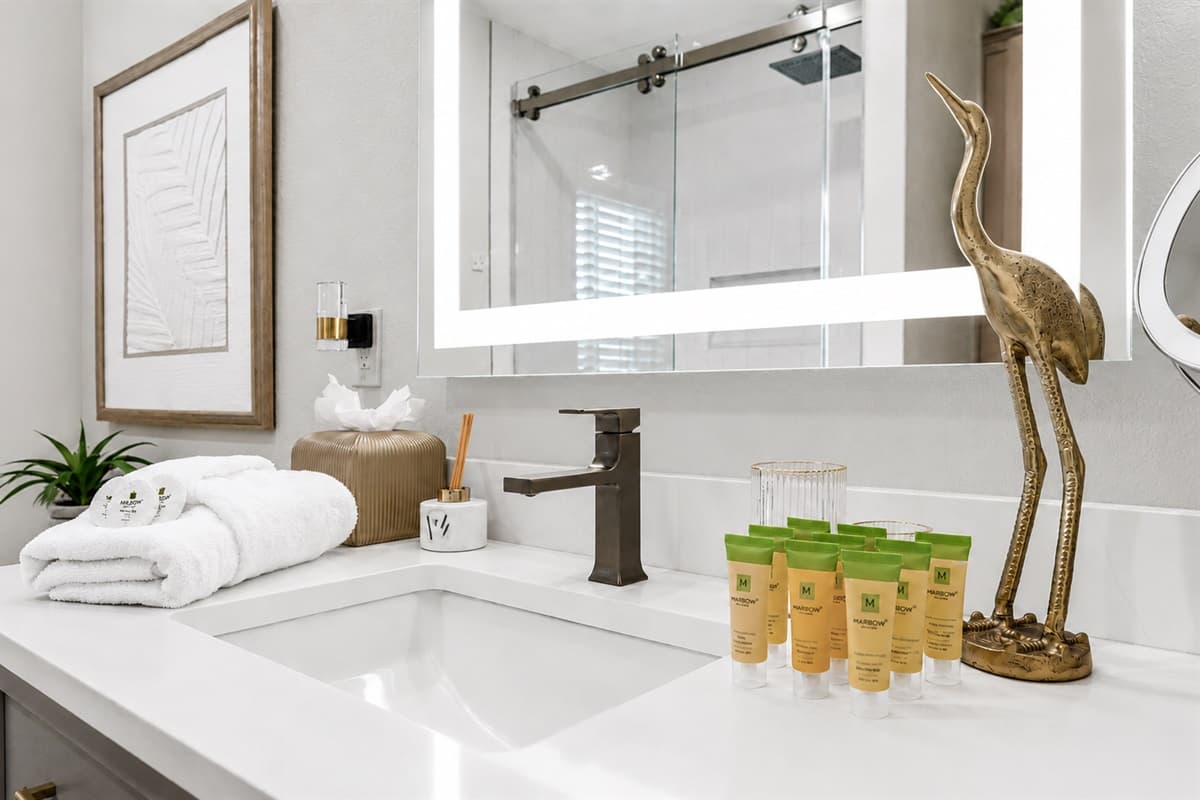 Elegant vanity detail with upscale décor, modern sink, and complimentary guest essentials.