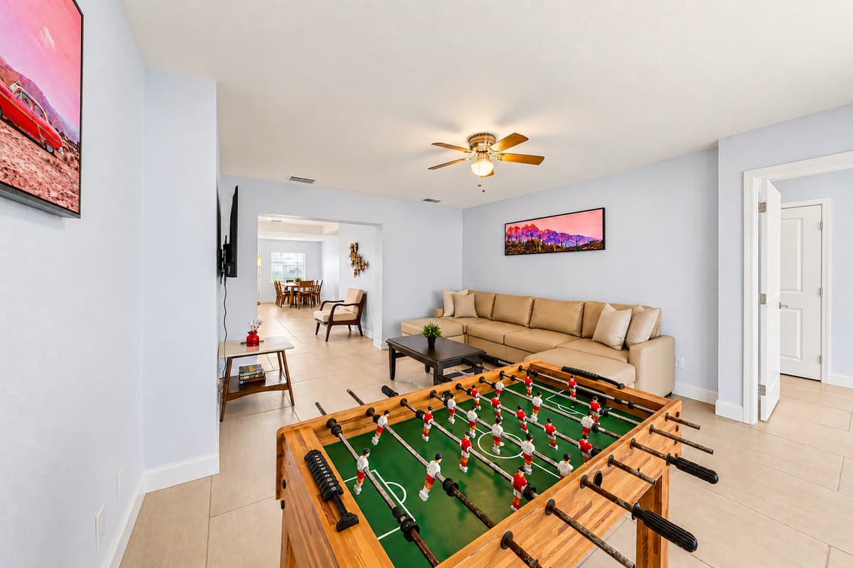 Foosball trash talk starts about ten minutes in. The game room opens right onto the living space, so the competition stays loud and the group stays together. Rain in the forecast suddenly stops mattering.