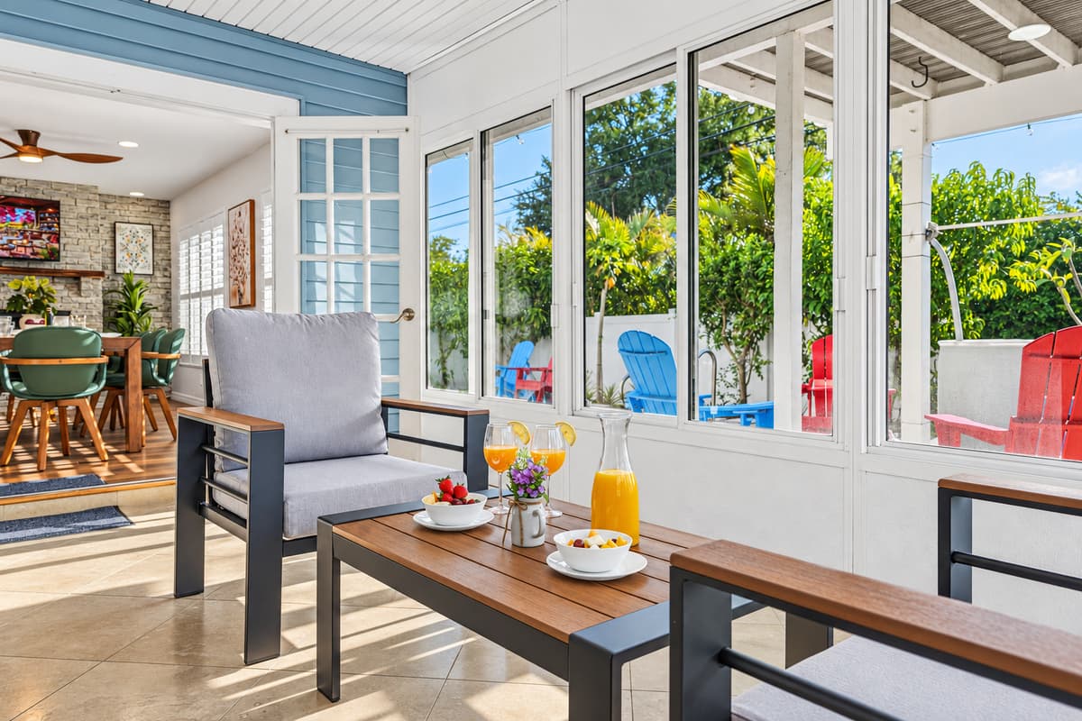 Inviting sunroom with large windows, cozy seating, and natural light throughout 