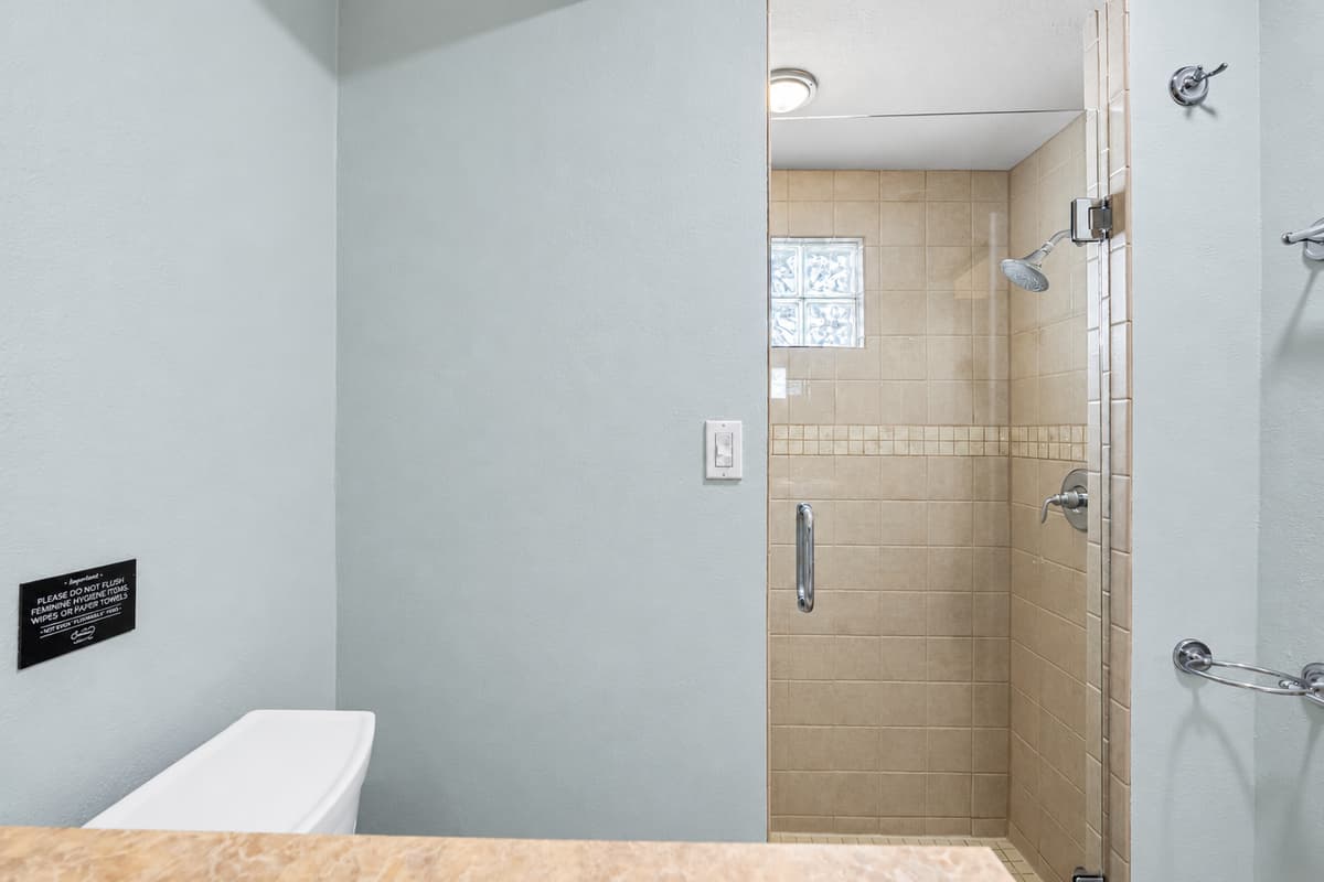 Designed with convenience in mind, featuring dual vanities and a spacious glass shower.