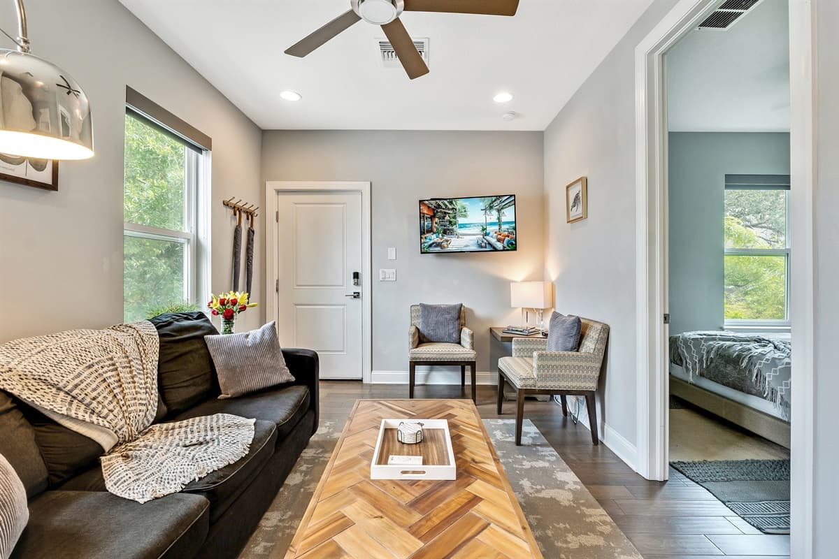 Large windows adorn the walls, allowing natural light to flood the room and bathe the space in a warm, inviting glow.