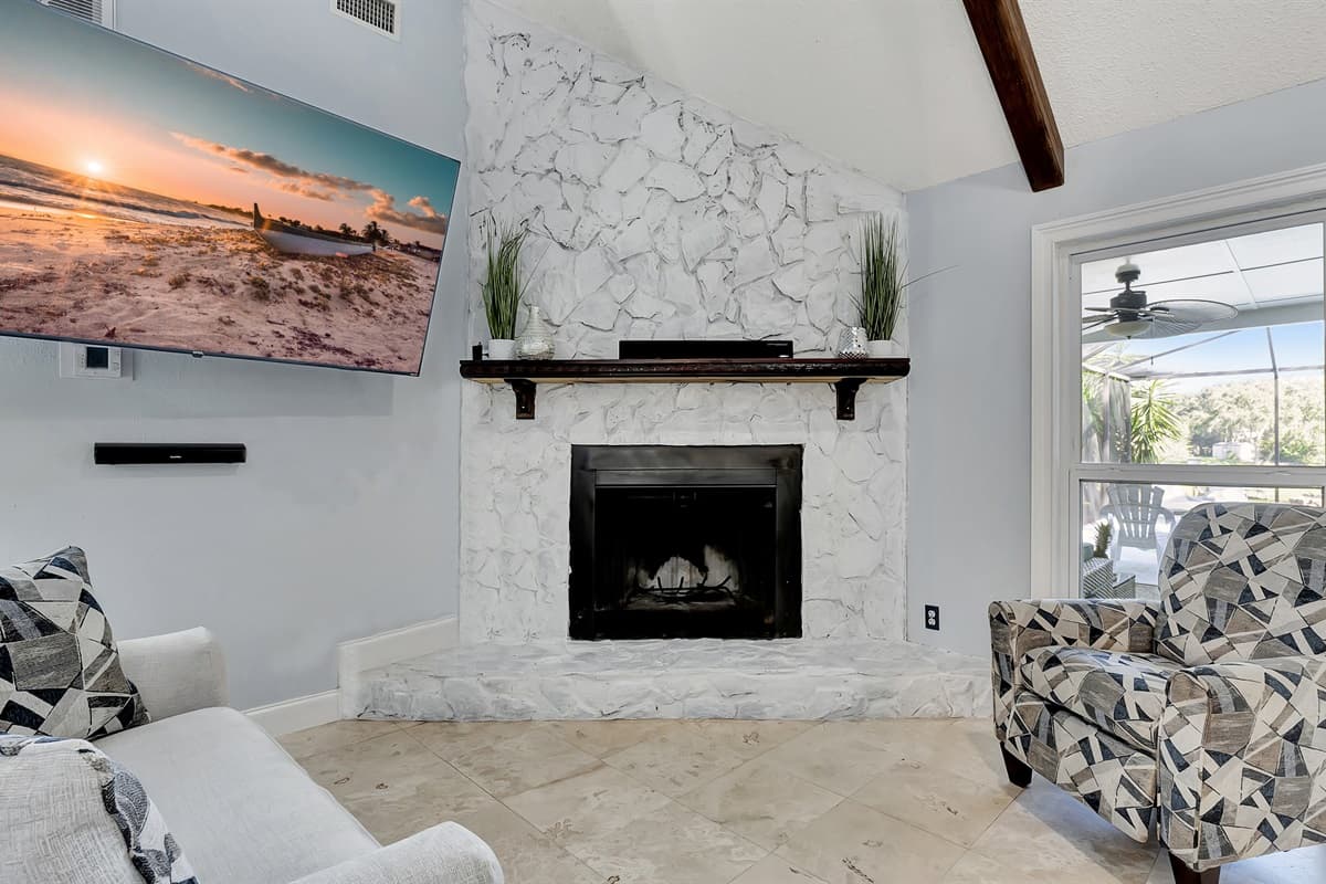 Plush couch beckons and the gentle glow of a fireplace sets the perfect ambiance.