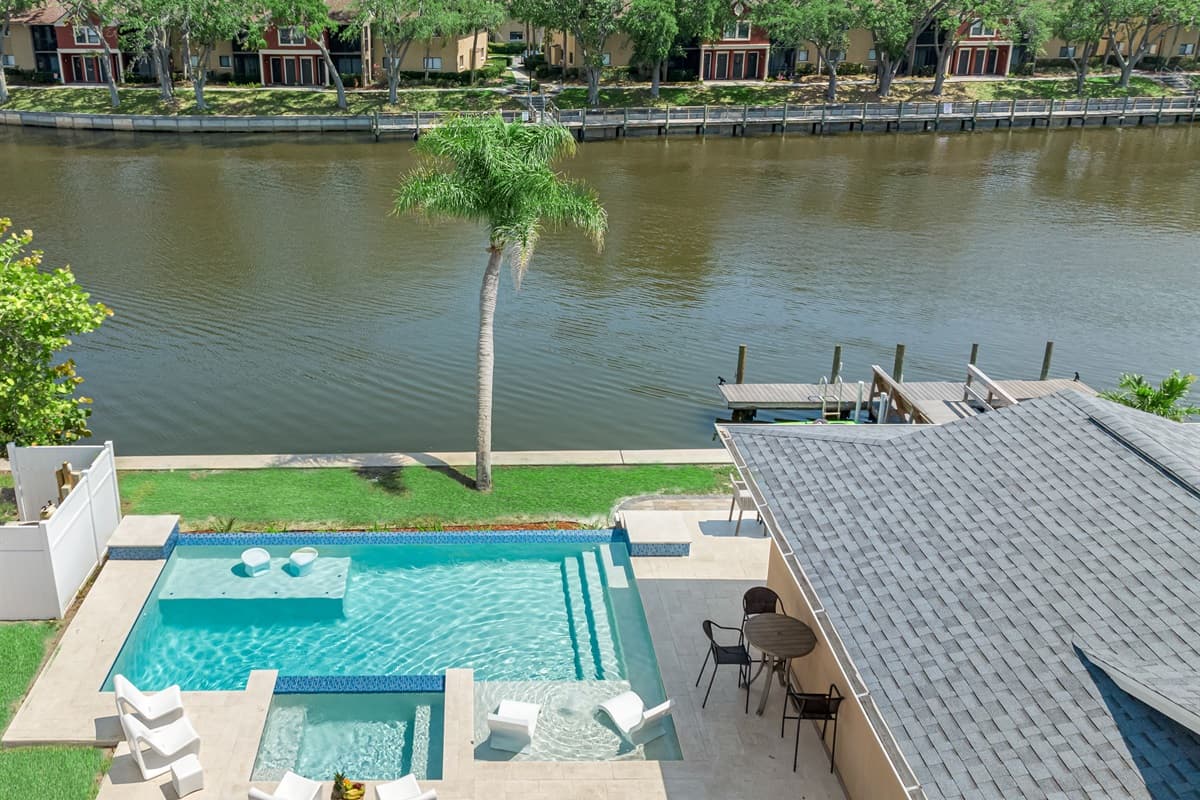 This water canal house with its inviting pool and captivating design is a sanctuary that seamlessly integrates luxurious living with the tranquil beauty of waterfront living.
