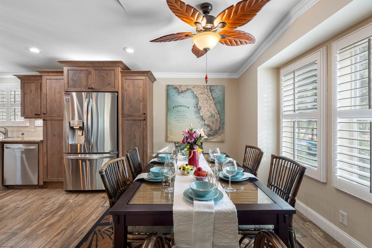 A stunning bay window fills the space with soft Florida sunshine, creating a warm mealtime atmosphere.