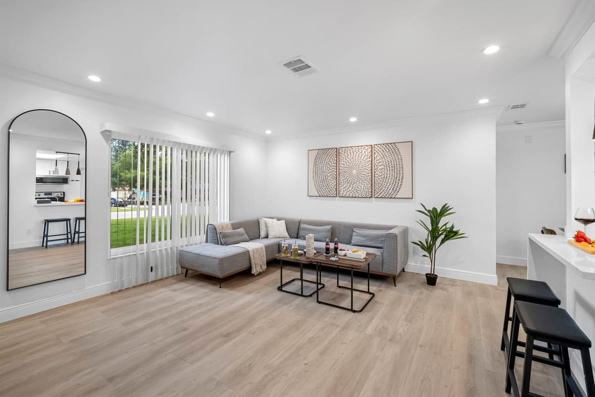 Enjoy the oversized smart TV and soundbar setup from the plush L-shaped sofa—perfect for Netflix binges and chill evenings.